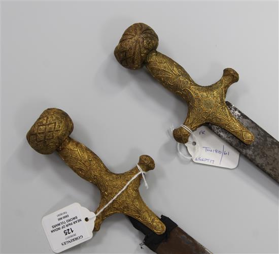 A near pair of Indian sword tulwars, late 19th century, L 81cm (blade)